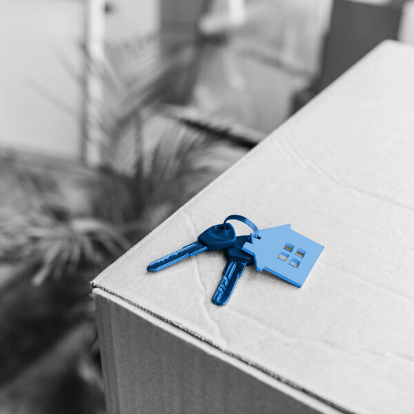 close-up view of keys from new house on cardboard box during relocation